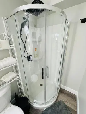 a shower with a glass door in a bathroom at True Haven in Prince George