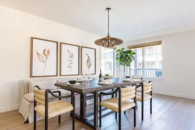 a dining room with a table and chairs at Creekside Elegance at Timberstone in Canmore