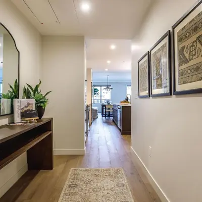 a hallway of a home with white walls and wooden floors at Creekside Elegance at Timberstone in Canmore