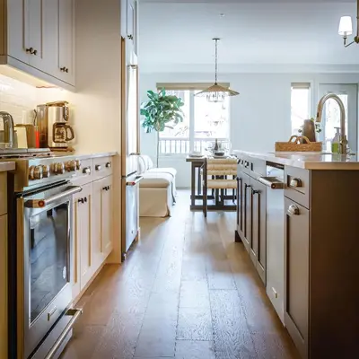 a kitchen with white appliances and a dining room at Creekside Elegance at Timberstone in Canmore