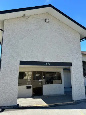 a building with the door open in a parking lot at Lakecity Inn in Penticton