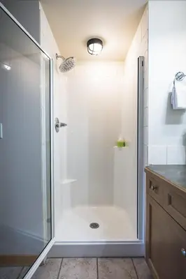 a shower with a glass door in a bathroom at Mountainside - Stunning Views Downtown Location in Canmore