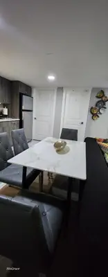 a living room with a white table and chairs at The Vaulted Oasis 2-bedroom with a Garden in Airdrie