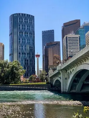 a bridge over a river in a city with buildings at Stay Heart of Calgary, Enjoy Night Life, Free Parking Incl in Calgary