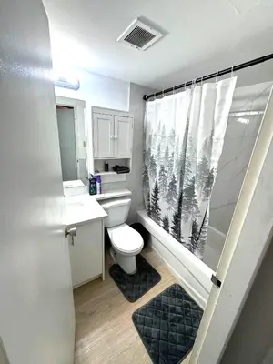 a small bathroom with a toilet and a shower at Stay Heart of Calgary, Enjoy Night Life, Free Parking Incl in Calgary