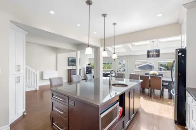 a kitchen with a large island and a dining room at Family-Friendly 3BR Home in Vancouver