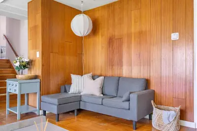 a living room with a gray couch and a table at Spacious Home with Indoor Pool in Vancouver
