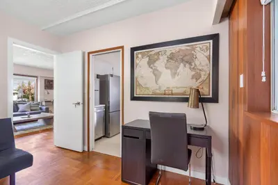 a home office with a desk and a map on the wall at Spacious Home with Indoor Pool in Vancouver
