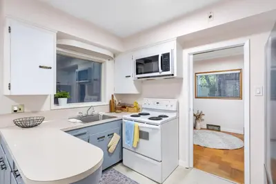 a white kitchen with a sink and a stove at Spacious Home with Indoor Pool in Vancouver