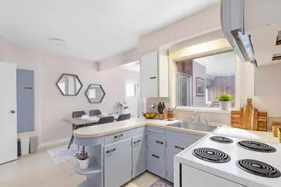 a kitchen with white cabinets and a sink at Spacious Home with Indoor Pool in Vancouver