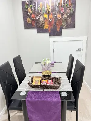 a dining room table with a purple table cloth at Range View Retreat/2BR Suite in Calgary
