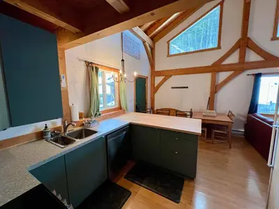 a large kitchen with a sink and a table at Alpenrose 4, Hottub, Mountains View, AC, sleep 5 in Golden