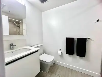 a white bathroom with a toilet and a sink at Central Stylish 3B2B near Richmond Center in Richmond