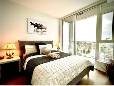 a bedroom with a bed and a large window at Central Stylish 3B2B near Richmond Center in Richmond