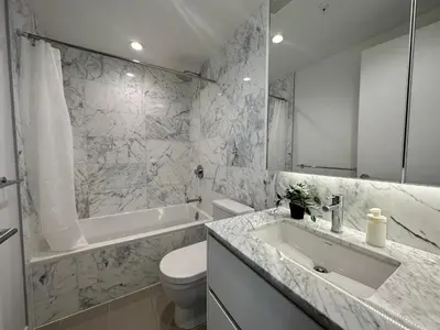 a bathroom with a sink and a toilet and a tub at Central Stylish 3B2B near Richmond Center in Richmond