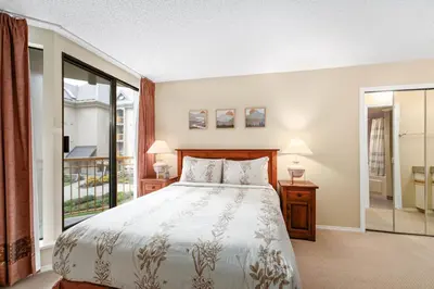 a bedroom with a bed and a large window at 1BR and Sofabed in Marquise, Close to Ski Hill, Fireplace, Hot Tub and Sauna, Gym in Whistler