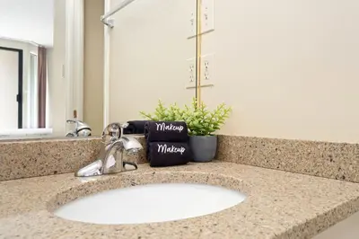 a bathroom counter with a sink and a mirror at 1BR and Sofabed in Marquise, Close to Ski Hill, Fireplace, Hot Tub and Sauna, Gym in Whistler