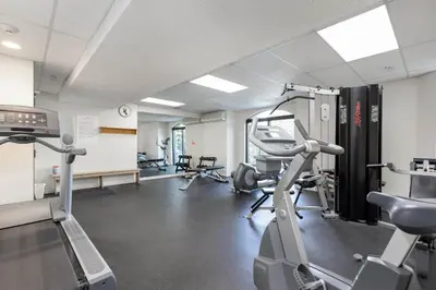 a gym with treadmills and ellipticals in a room at 1BR and Sofabed in Marquise, Close to Ski Hill, Fireplace, Hot Tub and Sauna, Gym in Whistler