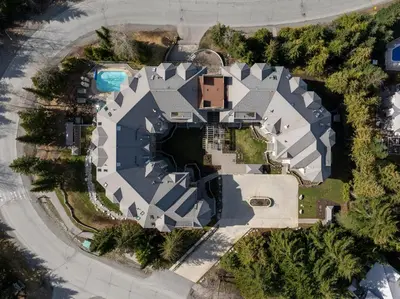 an aerial view of a mansion with a swimming pool at 1BR and Sofabed in Marquise, Close to Ski Hill, Fireplace, Hot Tub and Sauna, Gym in Whistler