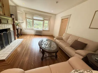 a living room with a couch and a table at Spacious Villa 6BR 3 BA - Free Parking - Near Kitsilano Beach & Attractions - 15' to DT in Vancouver