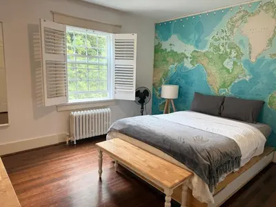 a bedroom with a bed with a map on the wall at Spacious Villa 6BR 3 BA - Free Parking - Near Kitsilano Beach & Attractions - 15' to DT in Vancouver