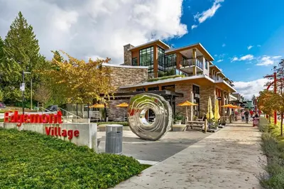 a building with a large wheel in front of it at Edge of the Mountain Villa in North Vancouver