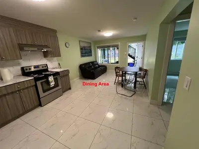 a kitchen with a living room and a dining area at Newton Suite in Surrey