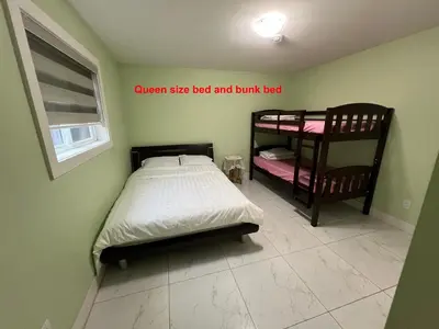 a bedroom with a twin size bed and bunk bed at Newton Suite in Surrey