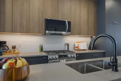 a kitchen with a bowl of fruit on a counter at Fenced Yard, Free Parking, 2 King Beds with AC in Calgary
