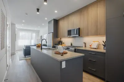 a kitchen with a sink and a counter top at Fenced Yard, Free Parking, 2 King Beds with AC in Calgary