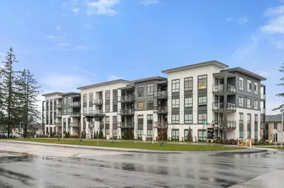 an apartment building on the corner of a street at Chic Condo with Stylish Amenities in White Rock in Surrey