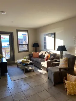 a living room with a couch and a table at PlayadelSol in Kelowna