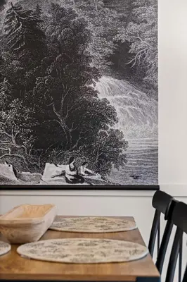 a painting hanging on a wall with two rugs on a table at Chic Mountain View - Pool & HotTub - Fireplace - BBQ! in Canmore