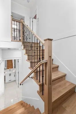 a staircase in a home with white walls at Modern Private 3BR House in Vancouver