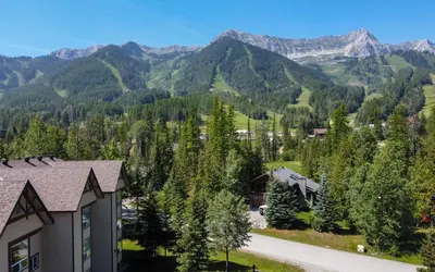 a house with a view of the mountains at Timberline - Spruce Lodge by Fernie Central Reservations in Fernie