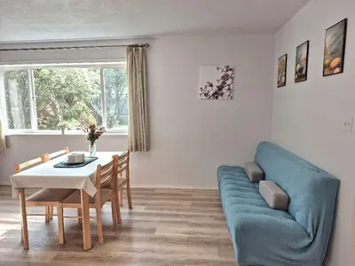 a living room with a blue couch and a table at Urban Retreat in Nanaimo