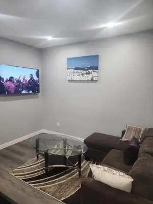 a living room with a couch and a glass table at Home in Northwest Calgary in Calgary