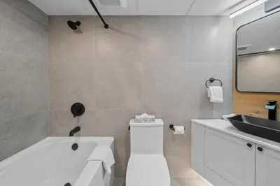 a bathroom with a white tub and a sink at The Summit Room Whistler Village in Whistler