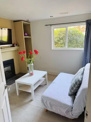a living room with a couch and a table with flowers at sweet home in Delta