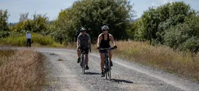 two people riding bikes down a dirt road at Serene Garden Suite in Delta