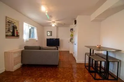 a living room with a couch and a table at Serene Garden Suite in Delta