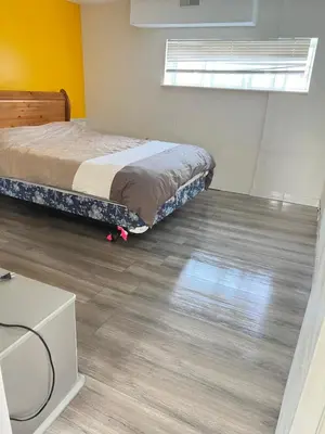 a bedroom with a bed and a wooden floor at Surrey central in Surrey