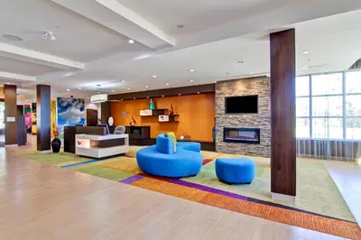 a lobby with a living room with a fireplace at Fairfield Inn & Suites by Marriott Kamloops in Kamloops