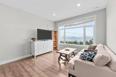 a living room with a couch and a flat screen tv at Nanaimo 2BR Oceanview Suite w/ Kitchen & Laundry in Nanaimo