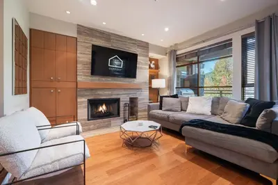 a living room with a couch and a fireplace at Fitzsimmons Walk 21 by Outpost Whistler in Whistler