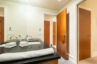 a bathroom with a sink and a large mirror at Fitzsimmons Walk 21 by Outpost Whistler in Whistler