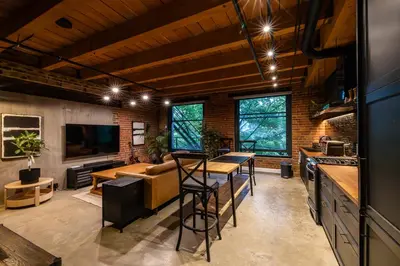 a kitchen and living room with a table and a couch at Stylish Industrial Loft - Historic Gastown in Vancouver