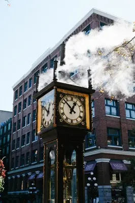 a clock tower on a street in front of a building at Stylish Industrial Loft - Historic Gastown in Vancouver