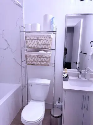 a white bathroom with a toilet and a sink at Amazing 2-bedroom house with WiFi in Edmonton in Edmonton