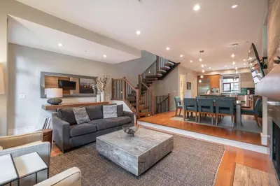 a living room with a couch and a table at Fitzsimmons Walk 35 by Outpost Whistler in Whistler